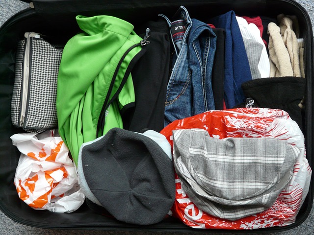 Clothes in a suitcase via https://pixabay.com/en/luggage-travel-holiday-packaging-64354/