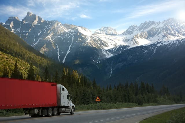 Truck driving in the Rockies via https://pixabay.com/photos/truck-road-shield-warning-canada-2755172/