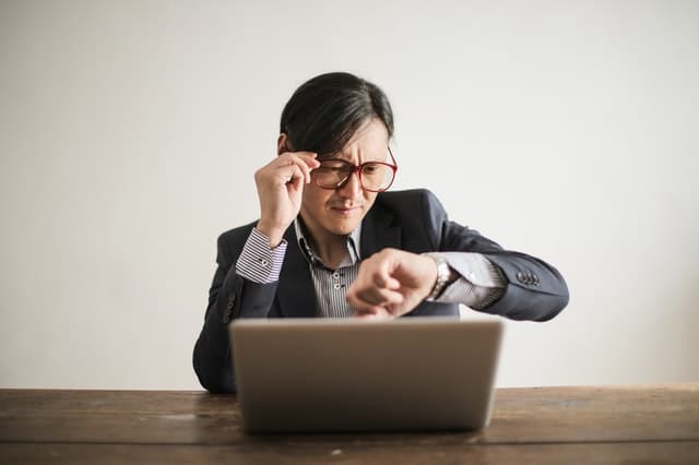Looking at watch https://www.pexels.com/photo/confused-businessman-checking-time-on-wristwatch-3760810/