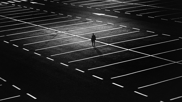 Lonely in an empty parking lot via https://pixabay.com/en/city-people-street-night-lights-1487891/
