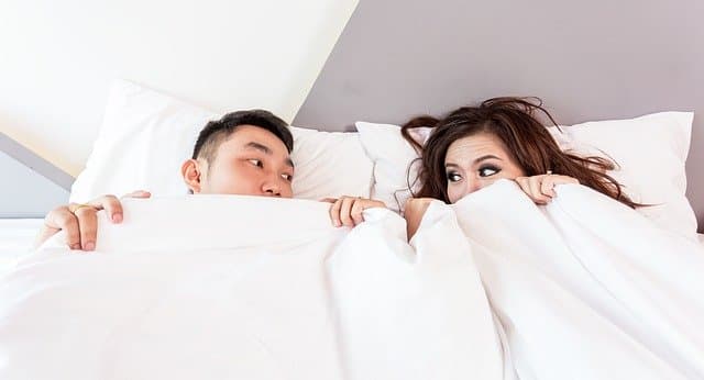 Couple in bed https://pixabay.com/photos/bed-sleeping-couple-covered-cover-1822497/